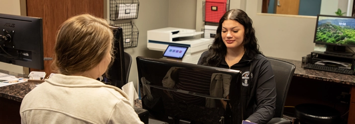 Chiropractic Maple Grove MN Front Desk And Patient Jada checking in a patient.