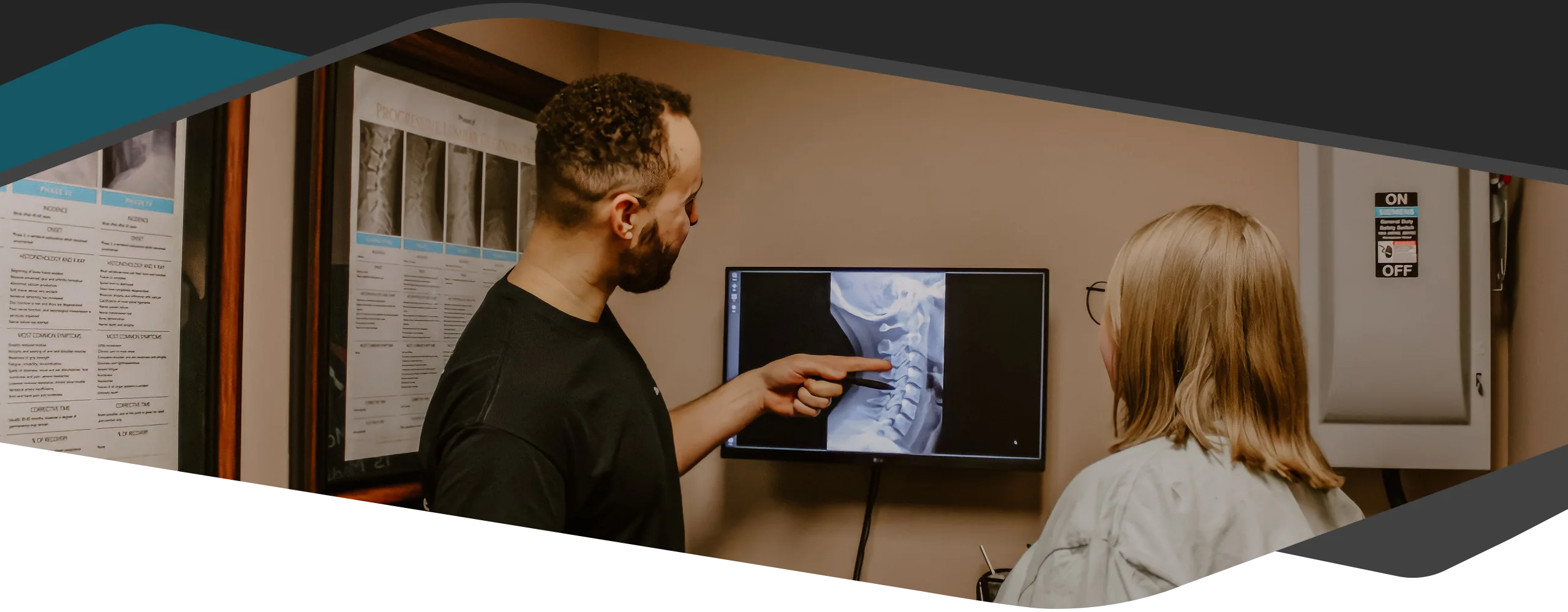 Chiropractor Maple Grove MN Kevin Jean With A Patient X Ray Dark Chiropractor Kevin Jean showing a patient their X-ray.
