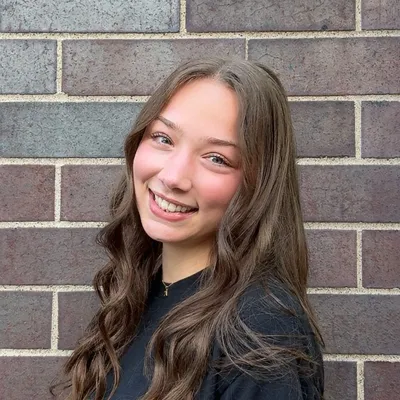 Women with brown hair smiling